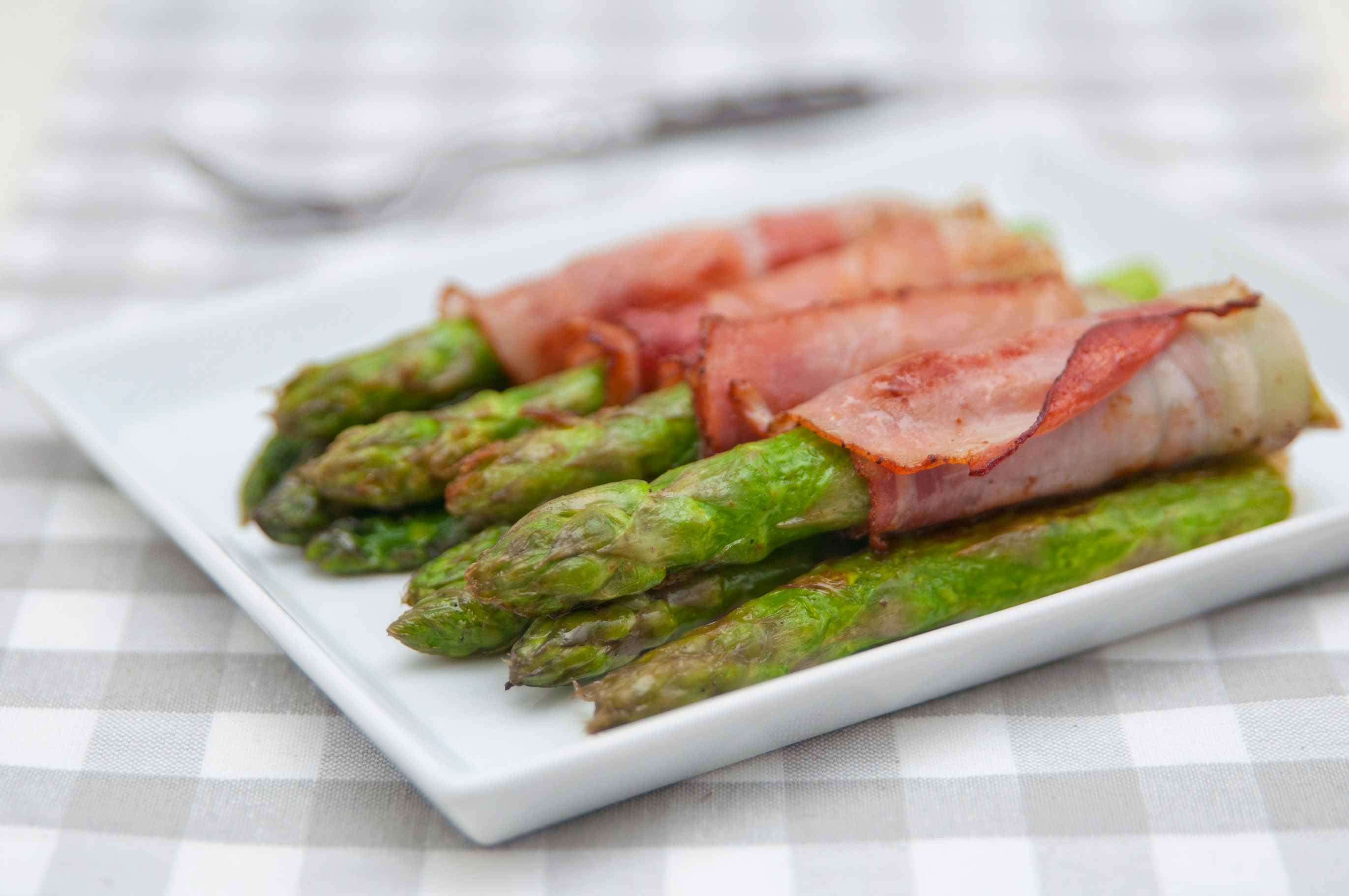 bacon wrapped asparagus on a plate 