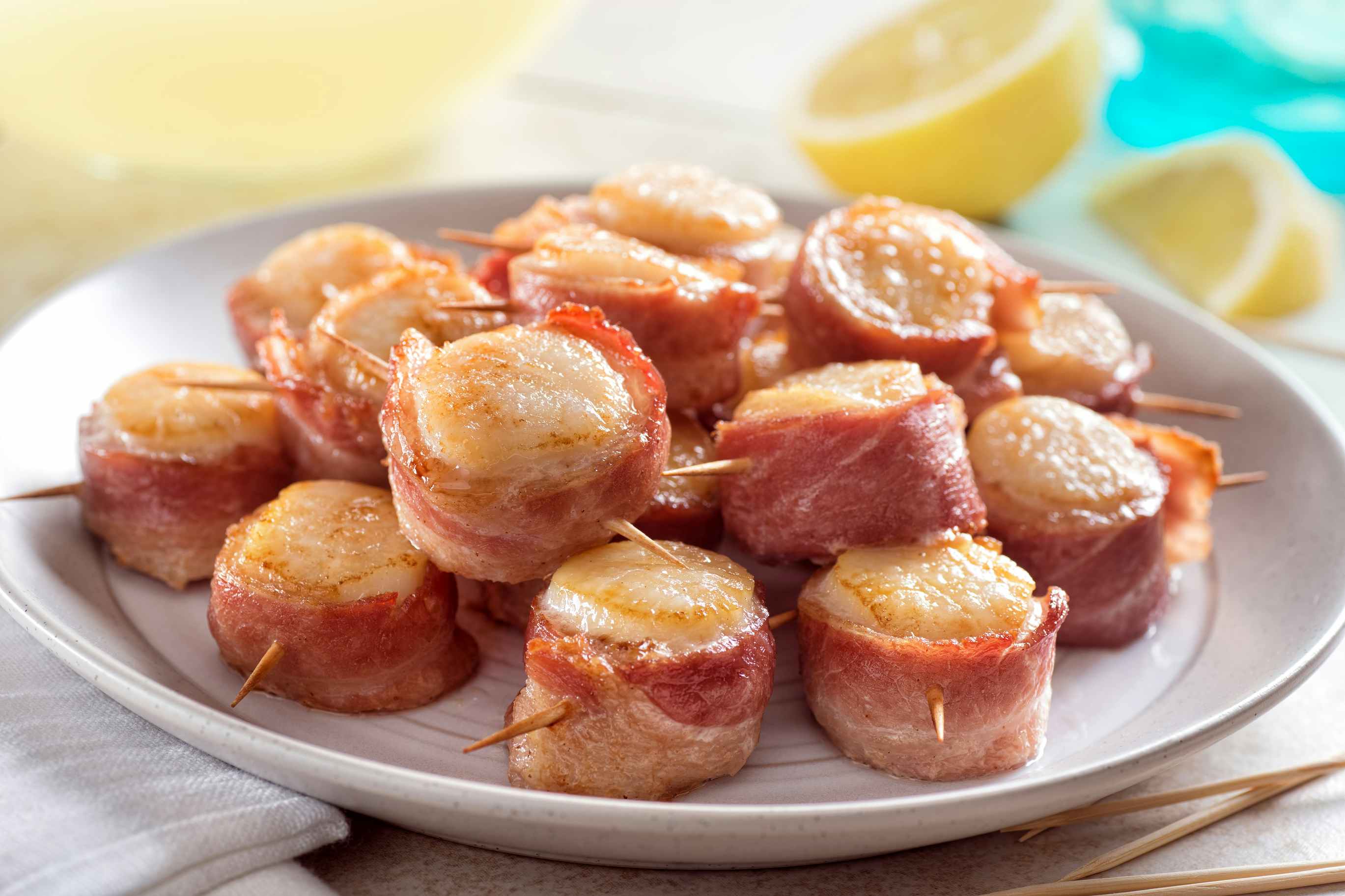 bacon wrapped scallops on a plate 