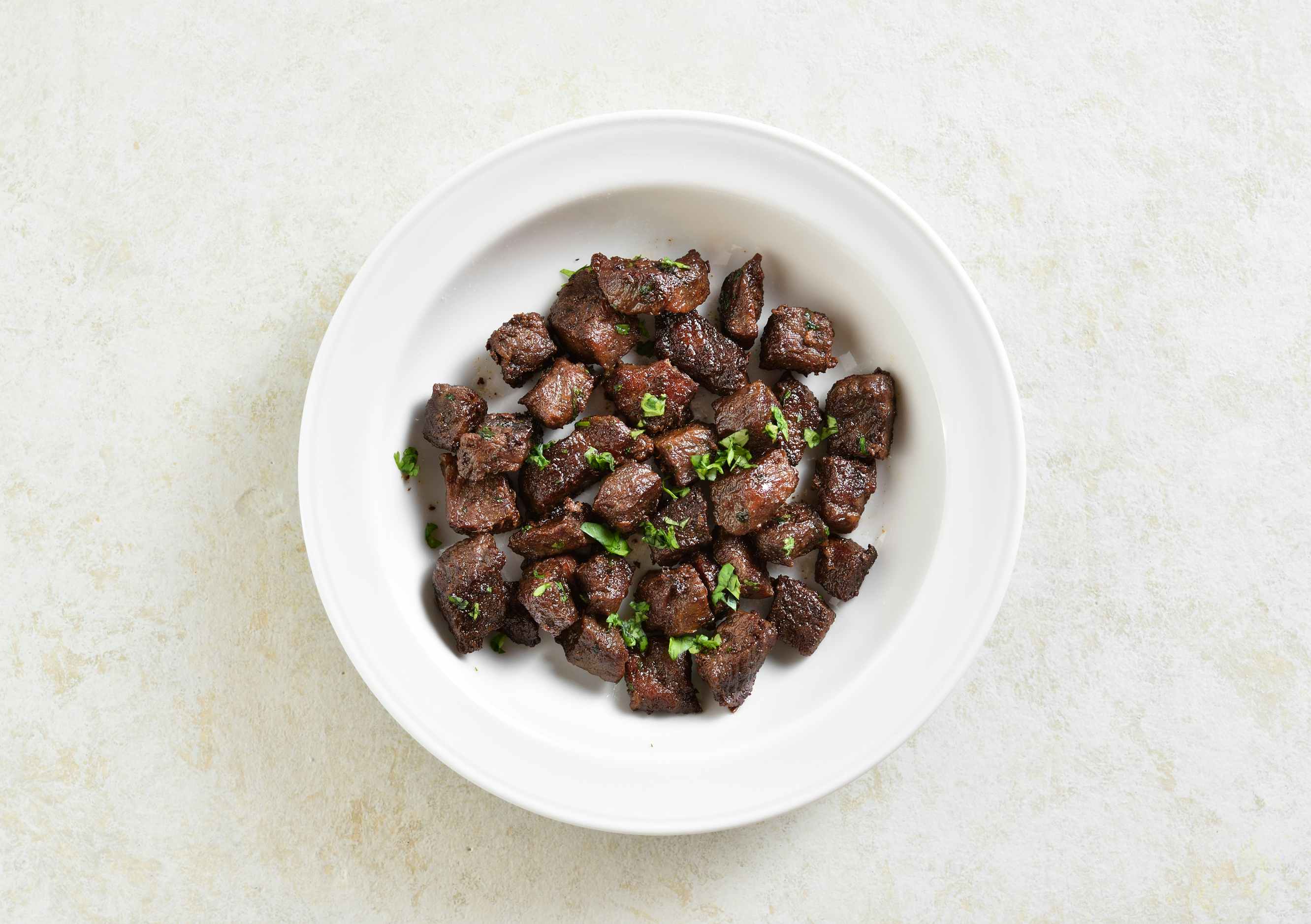 cooked steak bites on a plate 