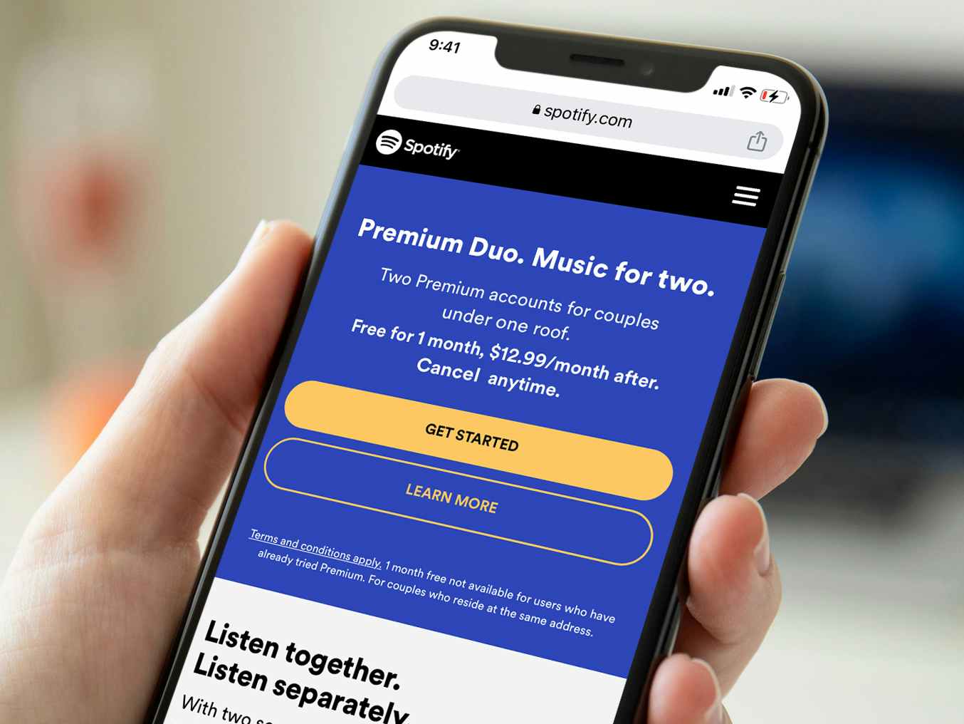 person holding a phone with a screeshot showing spotify premium duo plan details