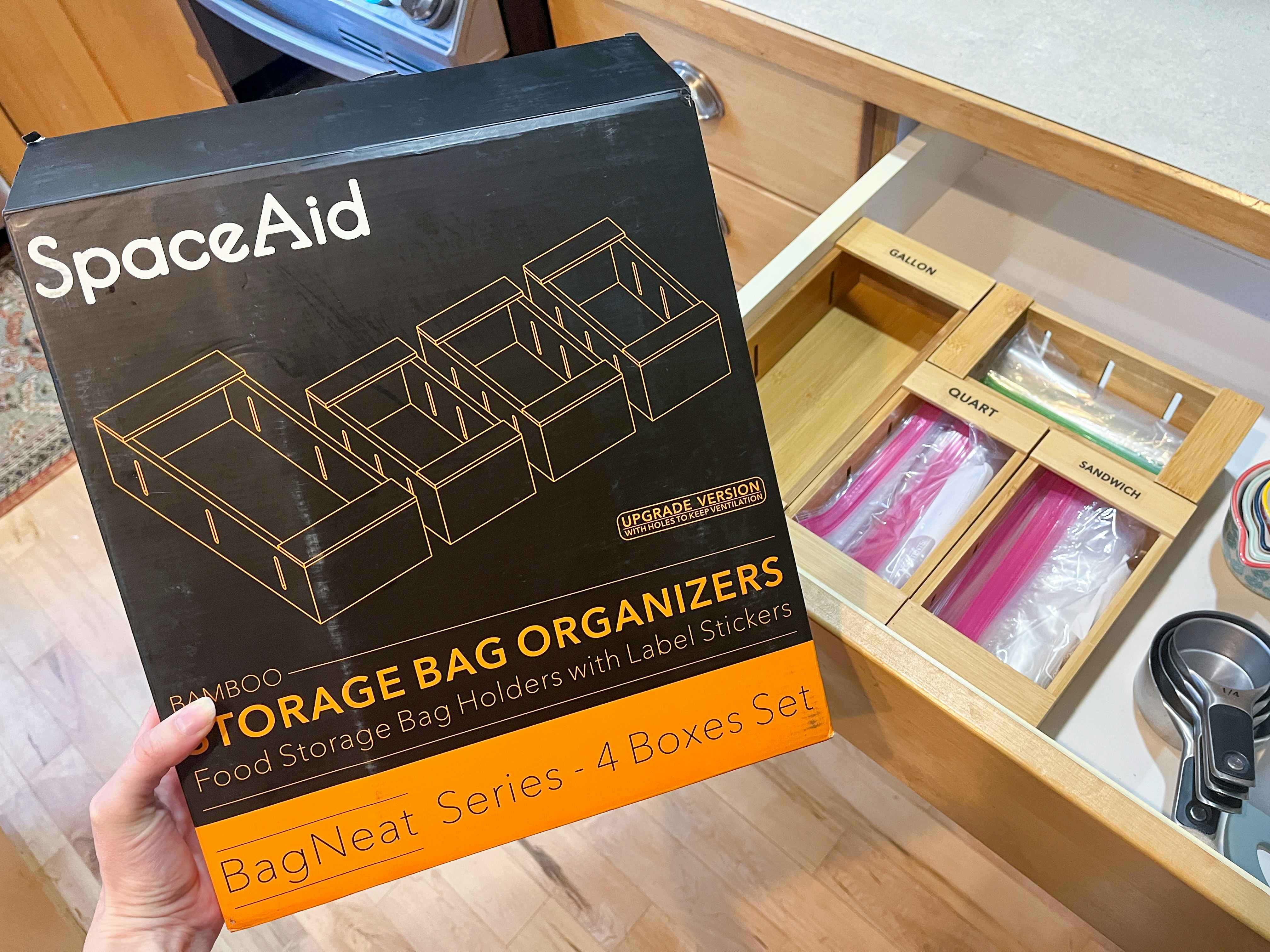 a hand holding the SpaceAid Food Storage Bag Organizer from Amazon in front of an open drawer