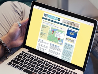 a person looking at the auto glass safety council website on their macbook 