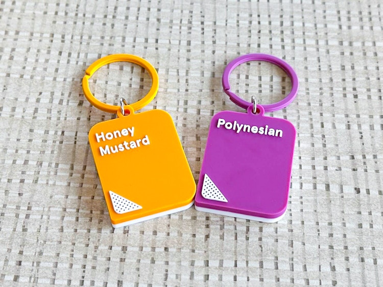 Two Chick-fil-A sauce keychains on a table