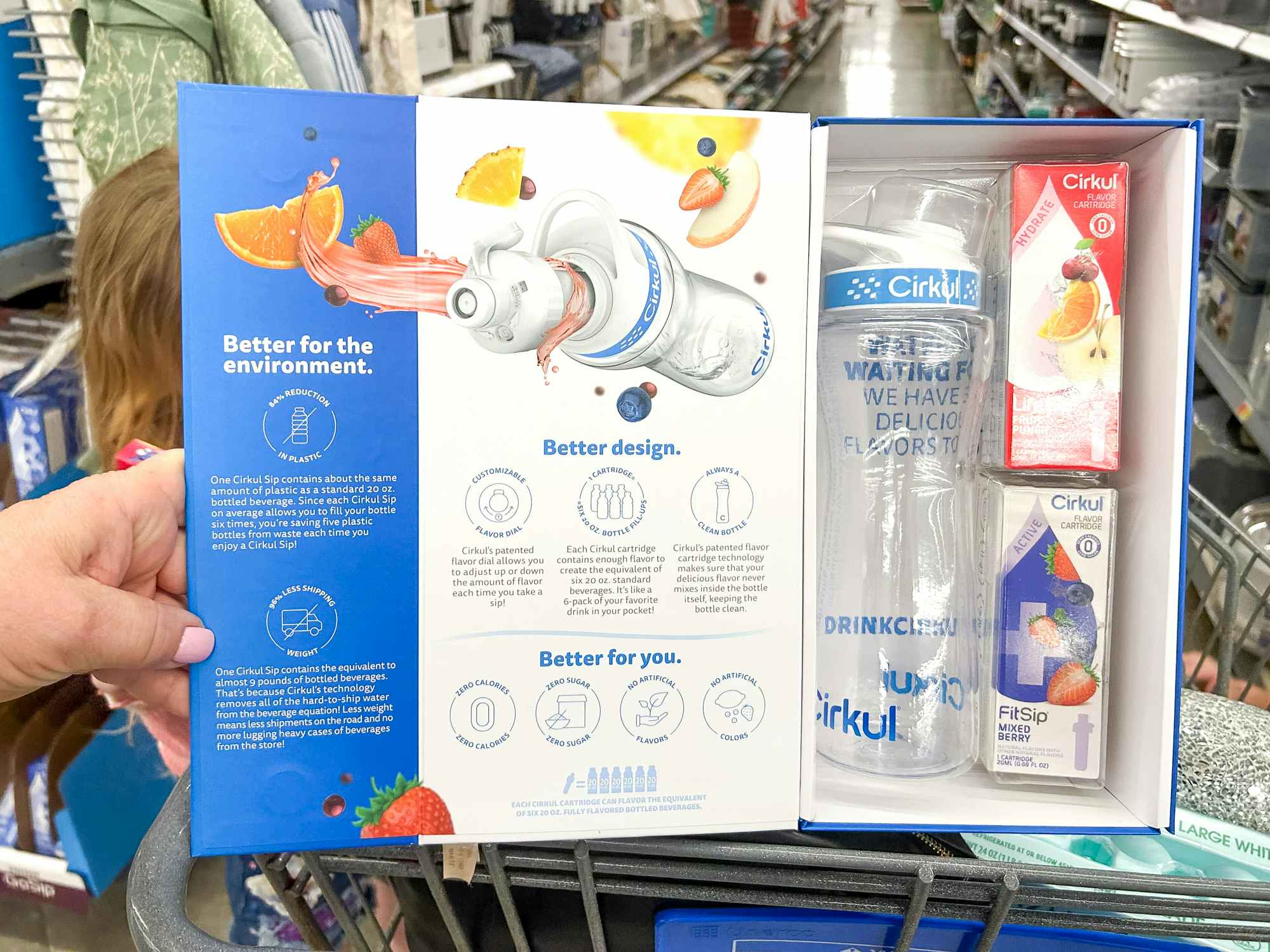Someone holding up a Cirkul water bottle box in a Walmart store, showing the contents of the box