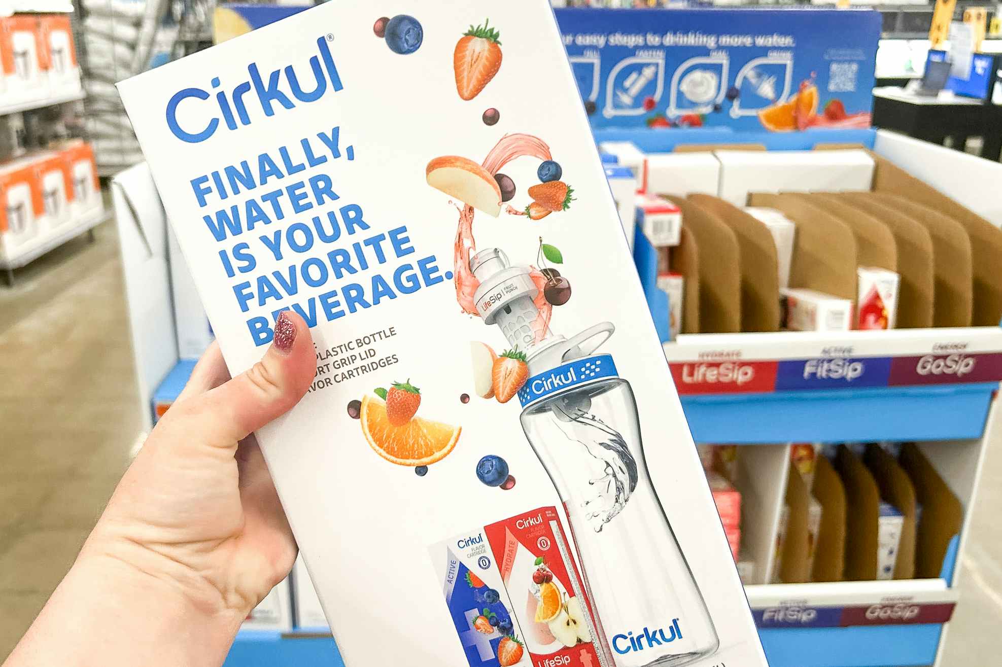 Someone holding up a Cirkul water bottle box in a Walmart store