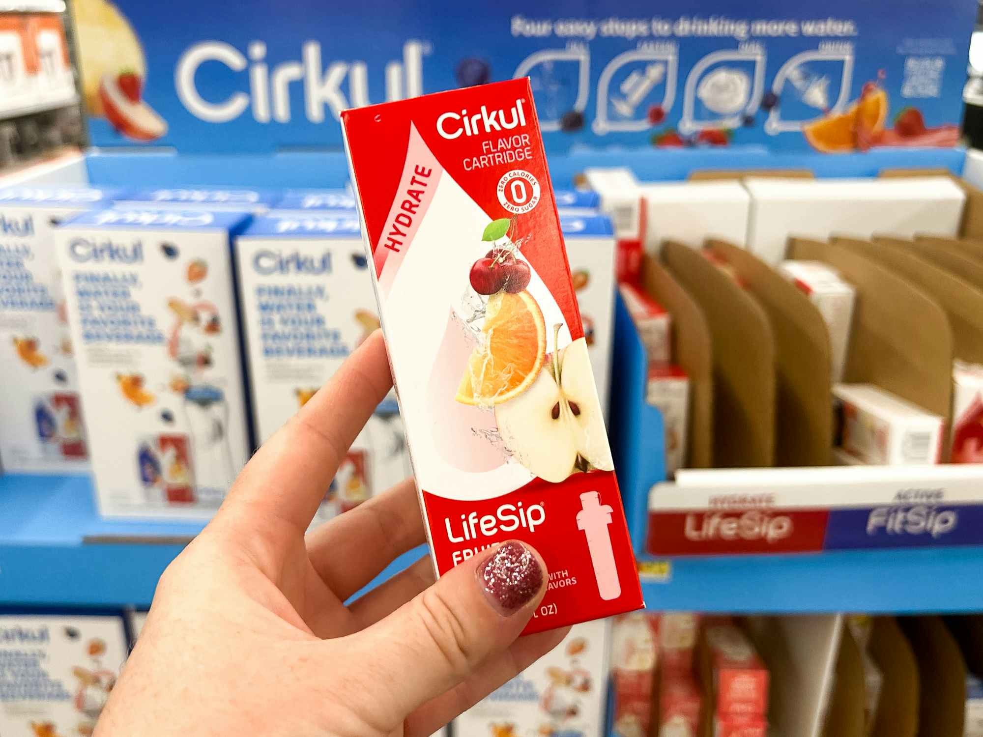 Someone holding up a Cirkul flavor box in a Walmart store