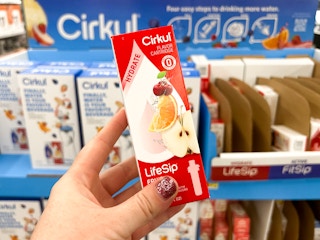 Someone holding up a Cirkul flavor box in a Walmart store