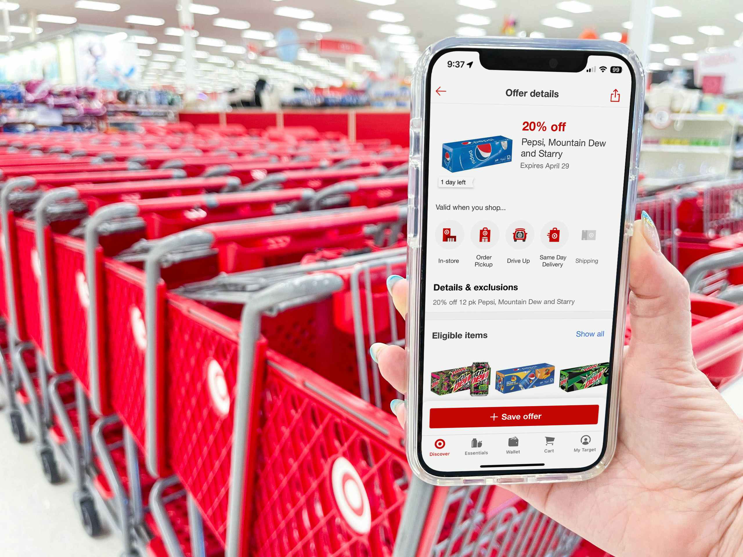 A person holding up their phone displaying the circle offer for 20% off Pepsi products on the Target app at the entrance of Target