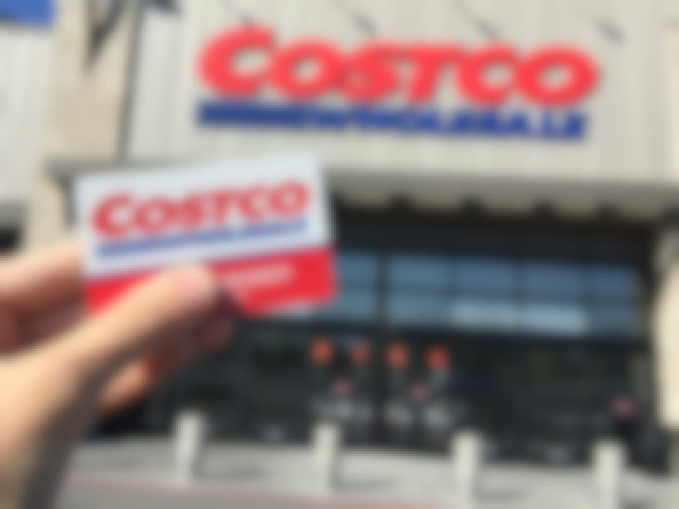 hand holding costco member card near store entrance
