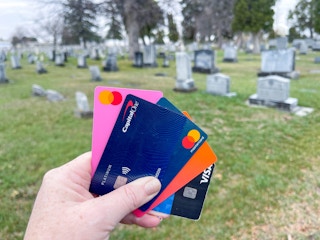 credit cards being held at a cemetery