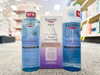 bottle of Eucerin hydrating cleansing gel, micellar water, and Skin Balance Day cream in aisle