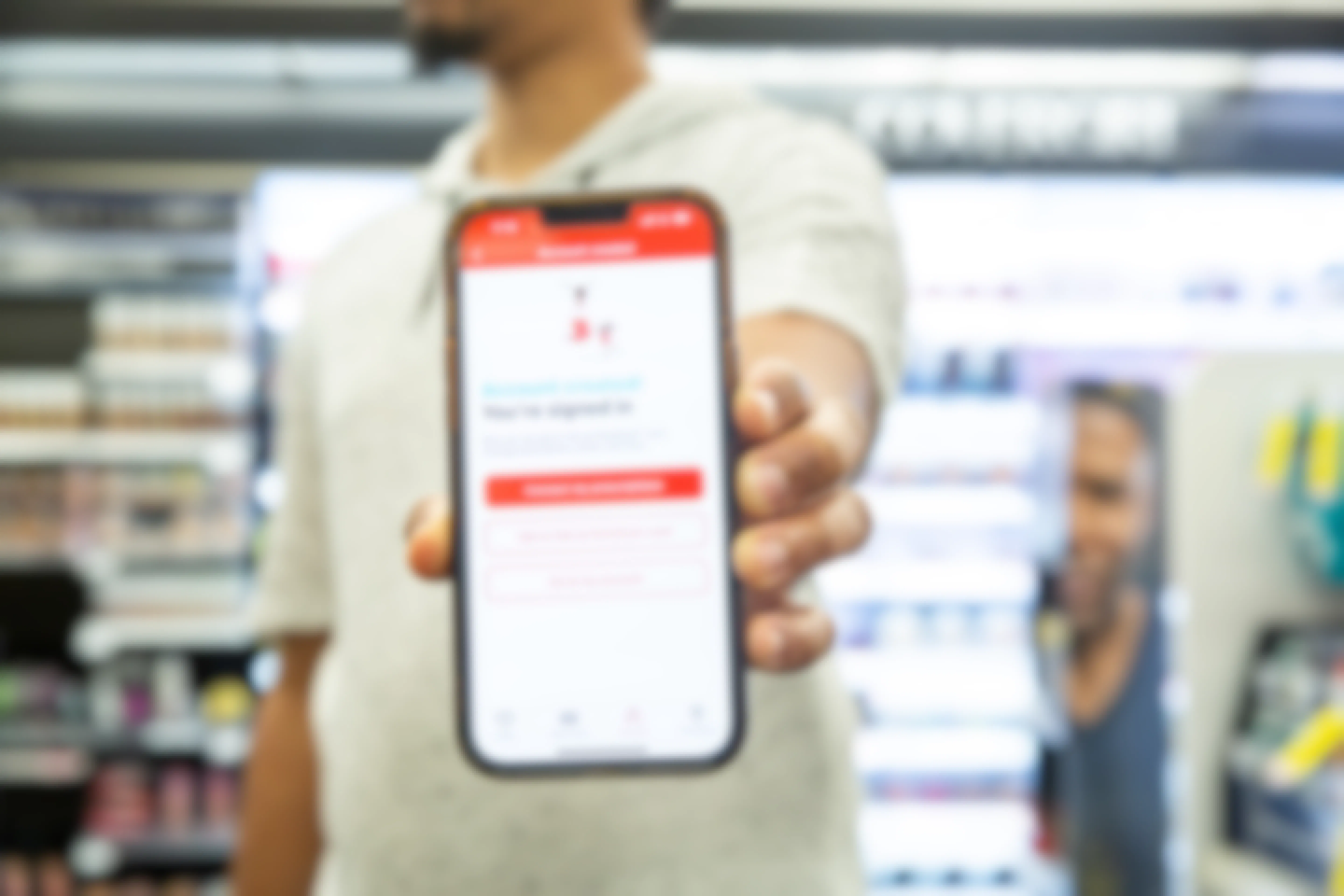 Hand holding phone that shows the CVS Pharmacy account creation page 