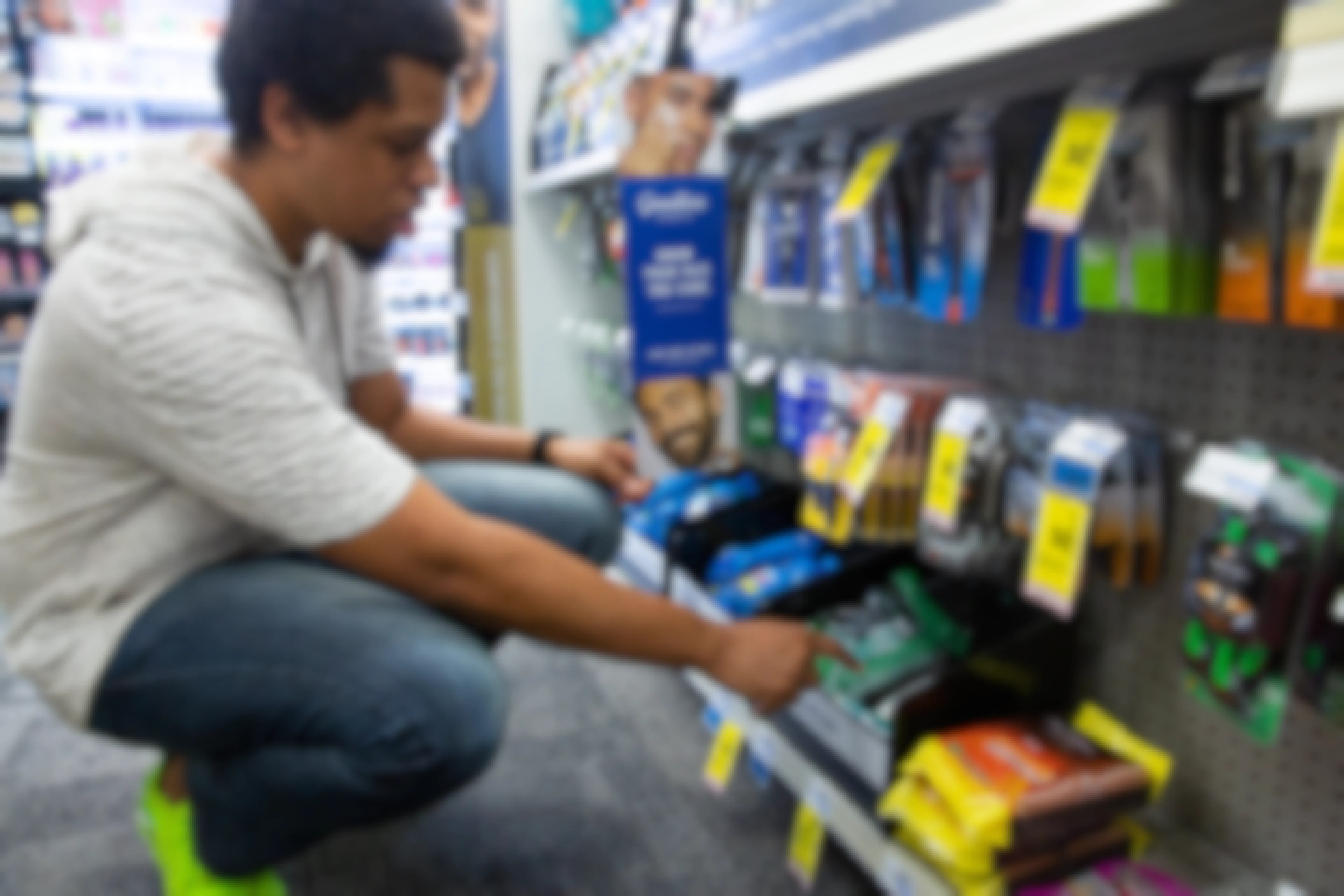 Person bending down to look closer at gillette branded razors at CVS Pharmacy