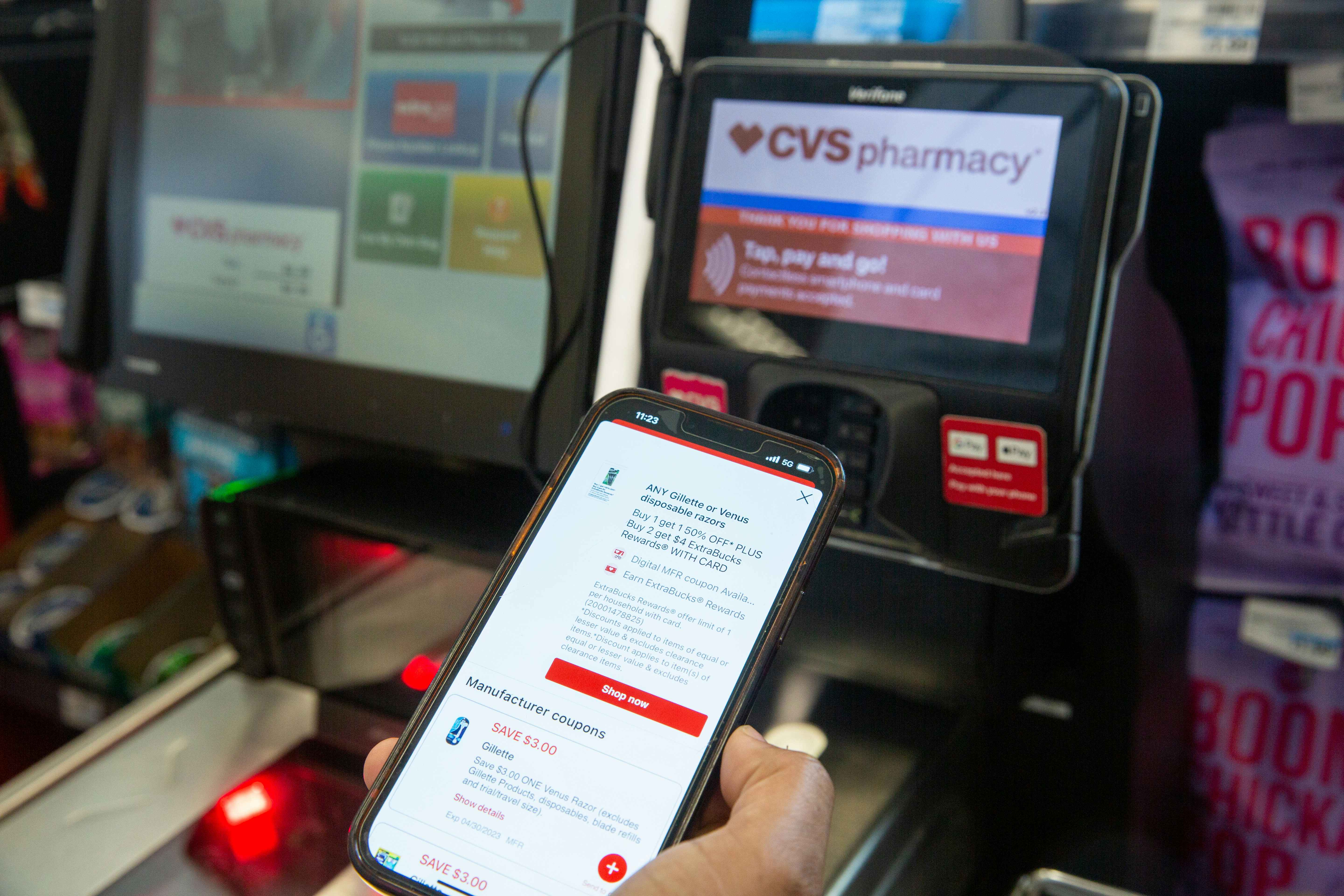  Showing digital coupons on the CVS app in front of the self-checkout