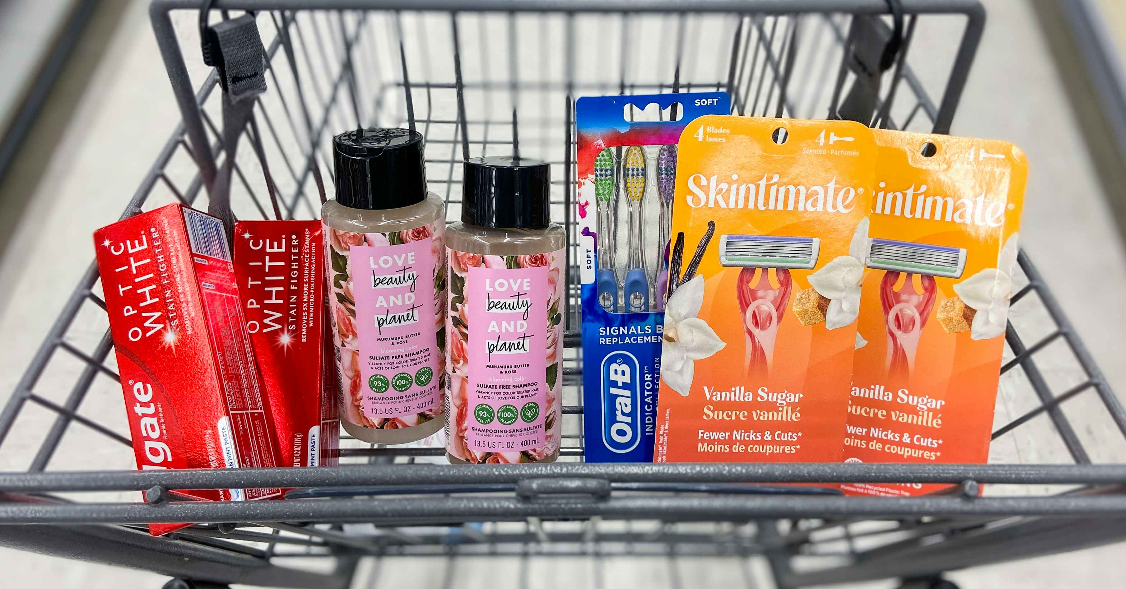 a cart with oral-b toothbrushes, skintimate razors, love beauty and planet hair care, and colgate toothpaste