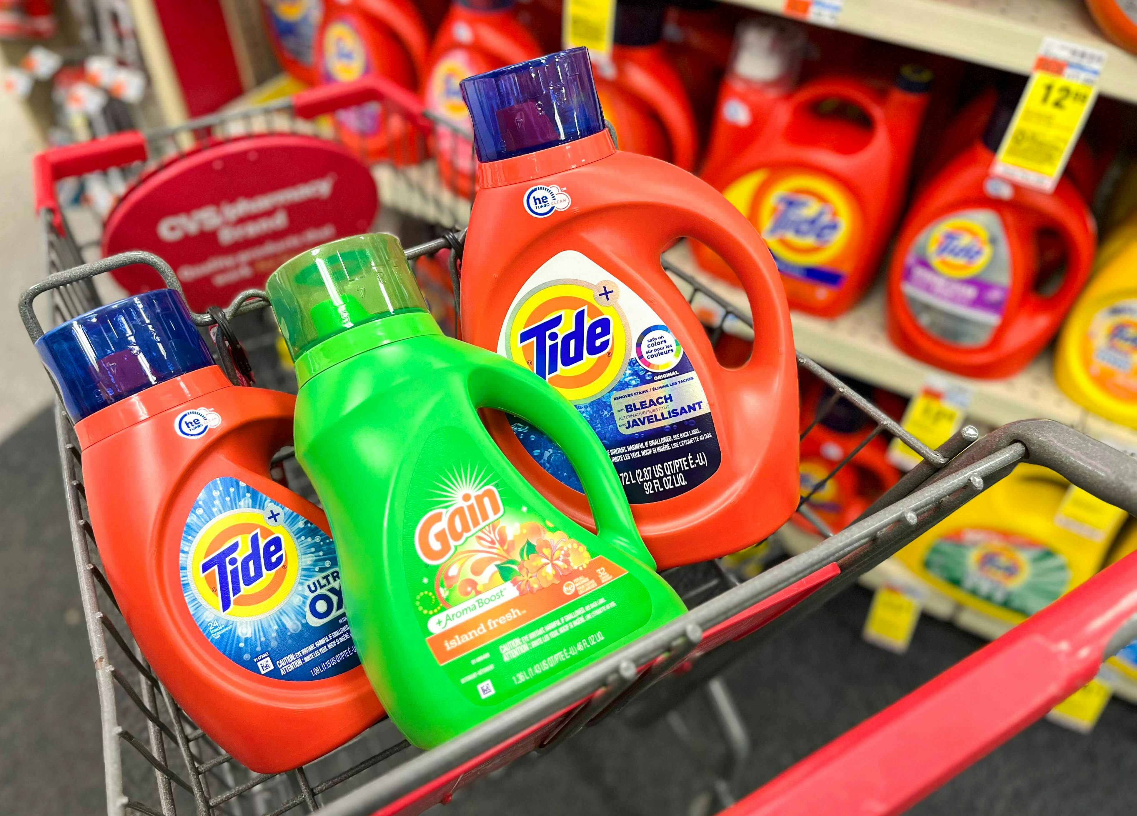 two bottles of Tide liquid laundry detergent and one bottle of Gain liquid laundry detergent inside shopping cart
