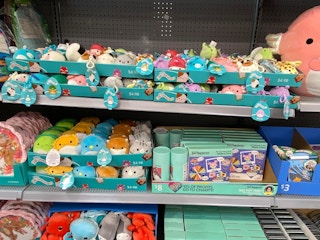 disney squishmallows keychains on display in walmart store aisle