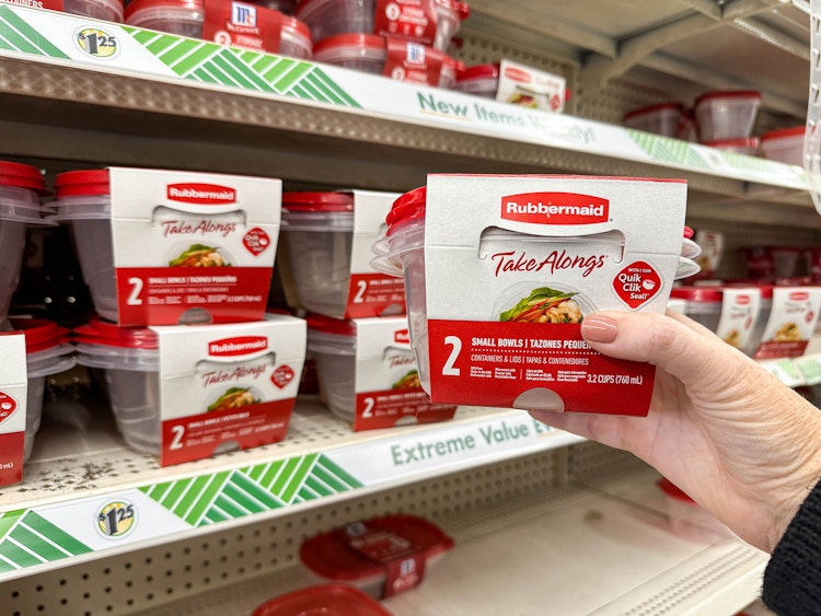 a person holding rubbermaid bowls in store 