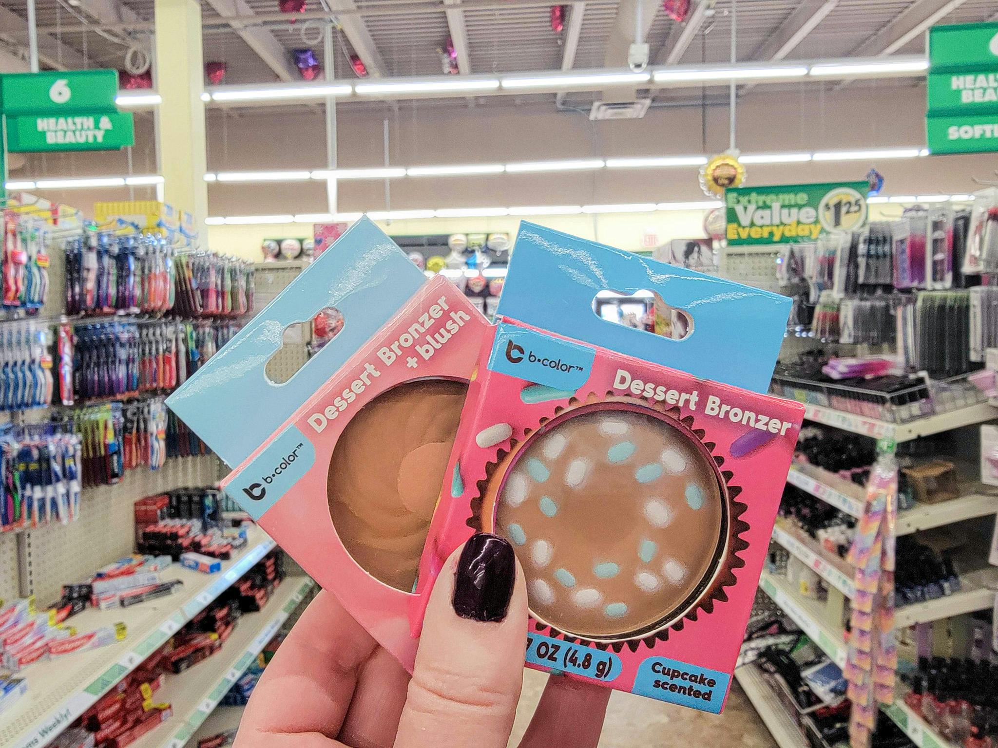 hand holding 2 bronzers