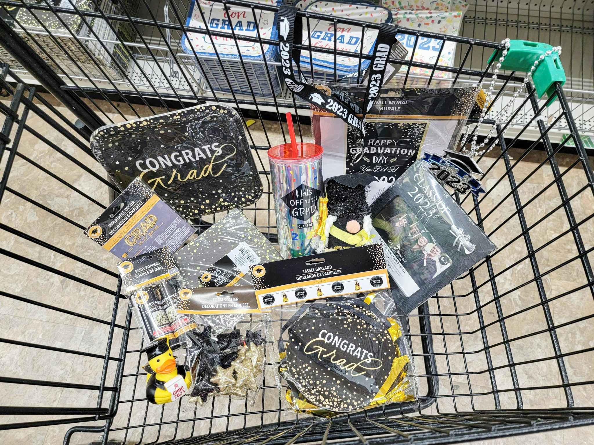 graduation party supplies in a cart