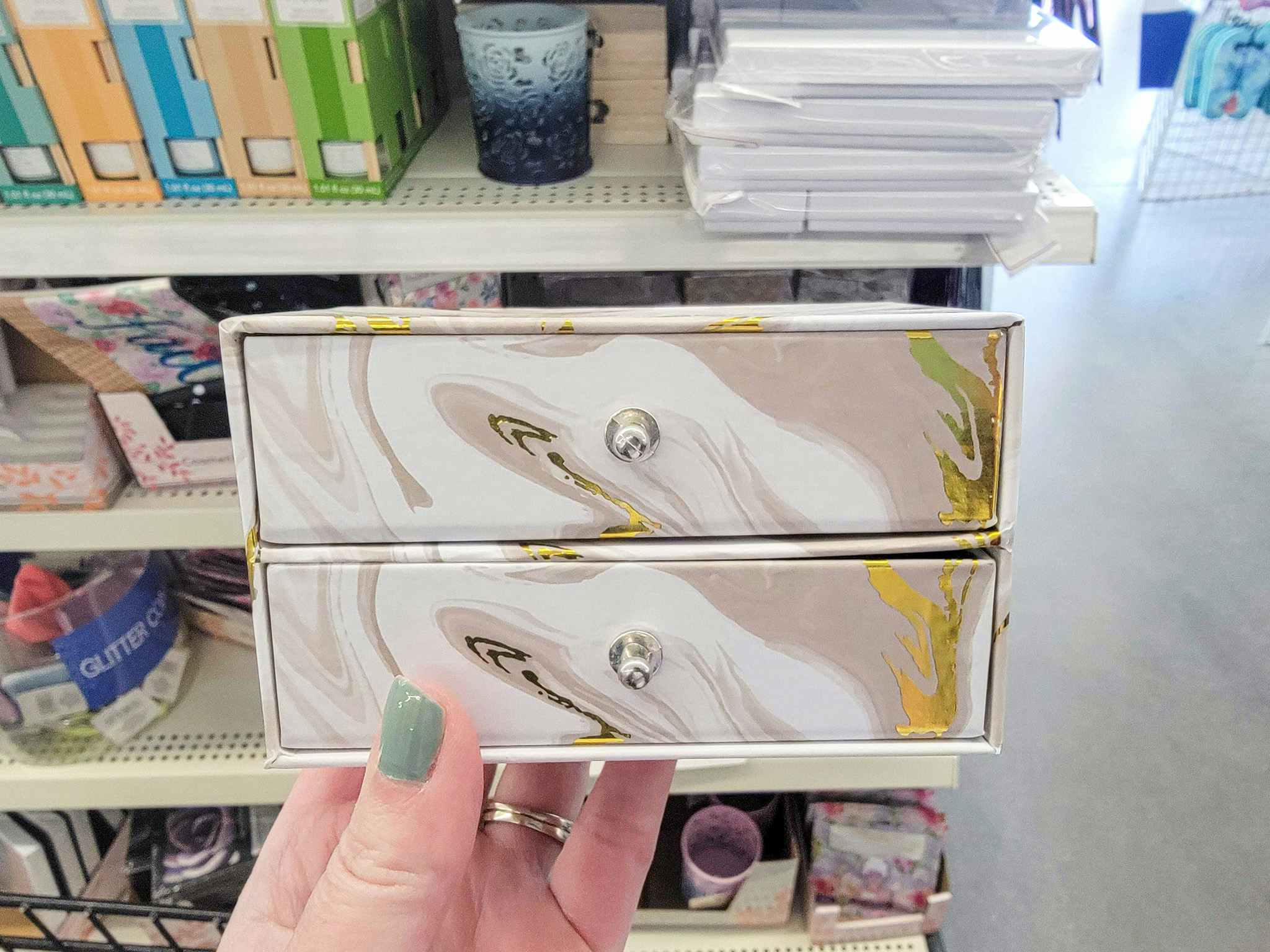 hand holding a 2-drawer jewelry box