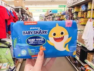 hand holding a package of baby shark wipes