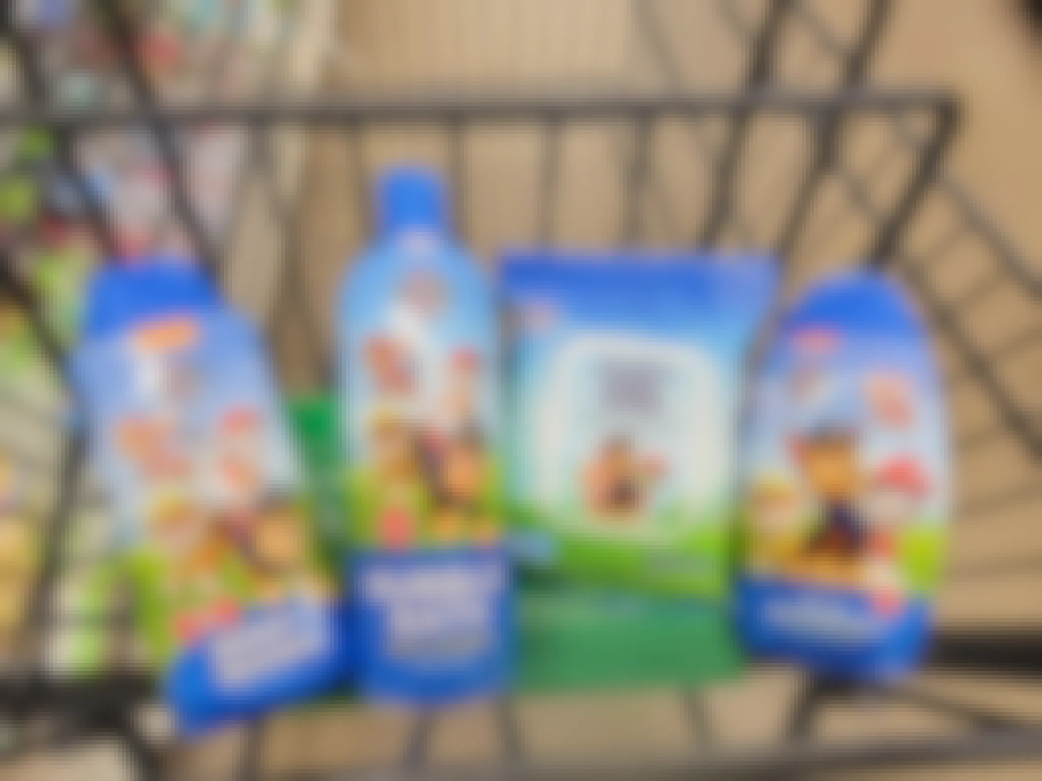 paw patrol body wash, bubble bath, nose wipes, and shampoo in a cart