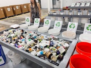 recycling bins with empty makeup bottles in them