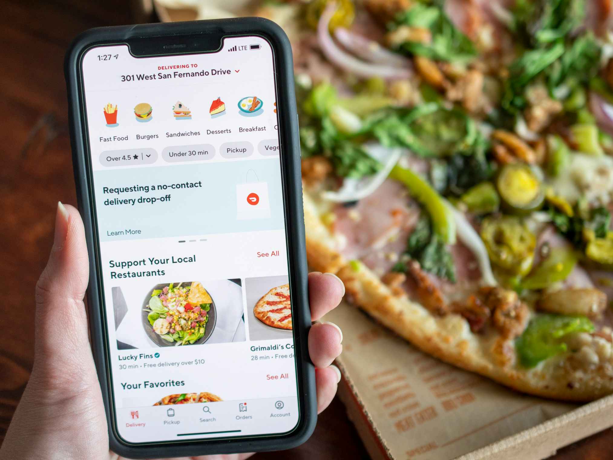 Doordash app open on iphone in front of a pizza