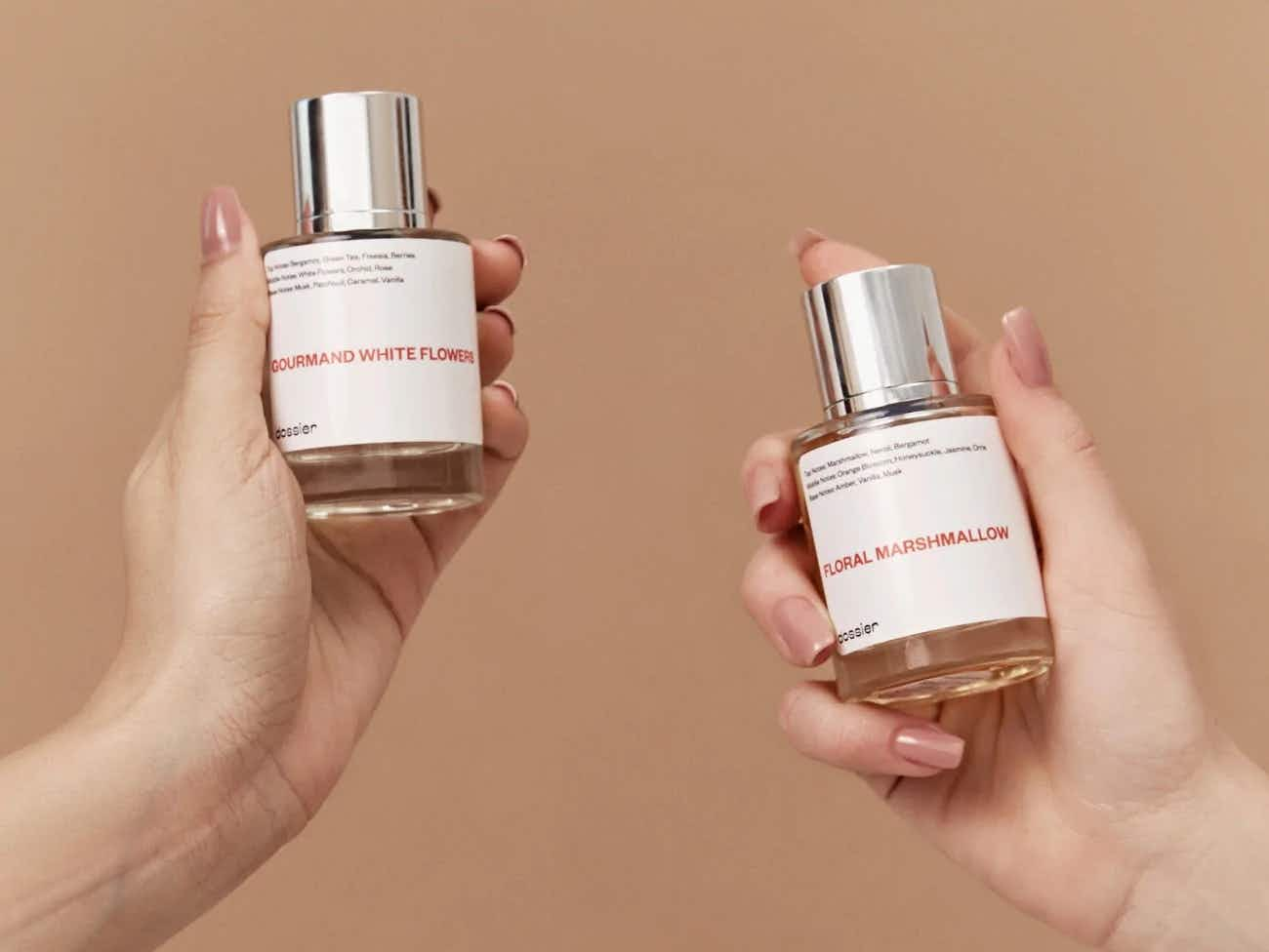 Dossier fragrances held by two hands