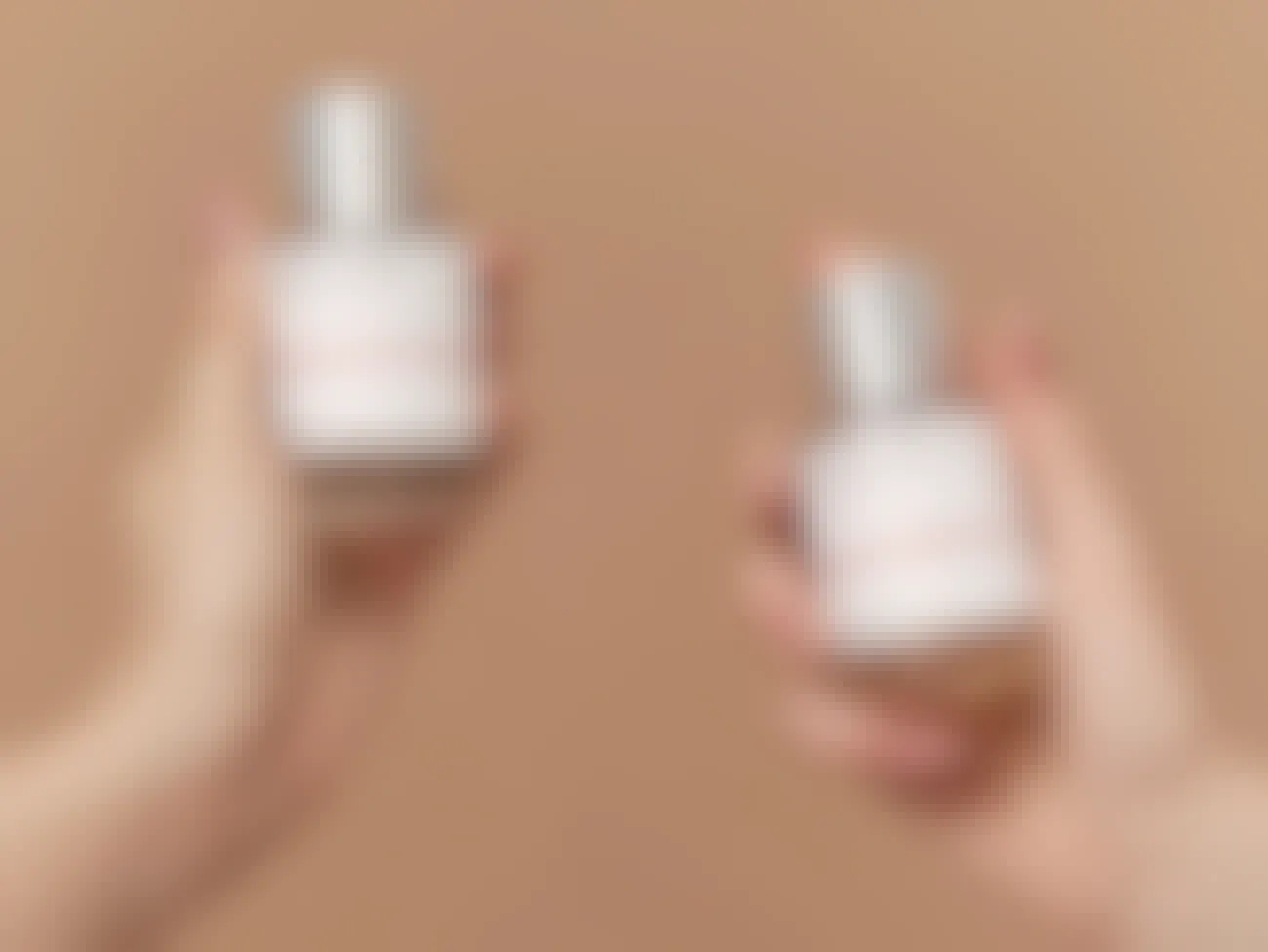 Dossier fragrances held by two hands