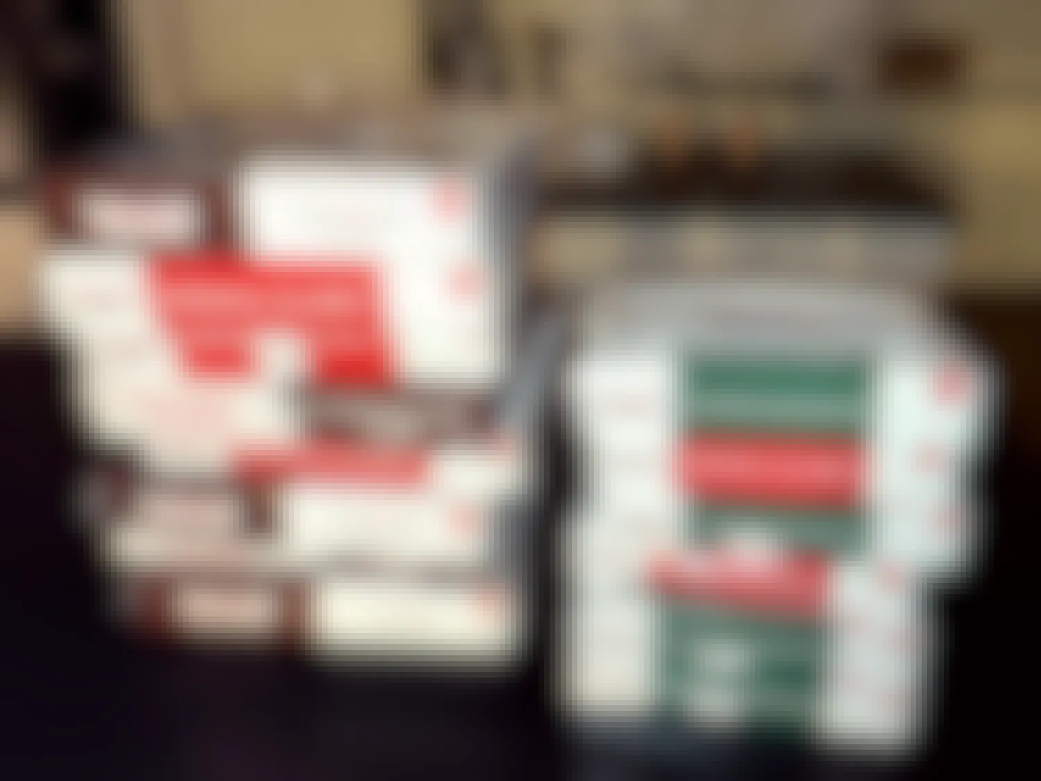 approximately a dozen boxes of krispy kreme doughnuts on a kitchen countertop