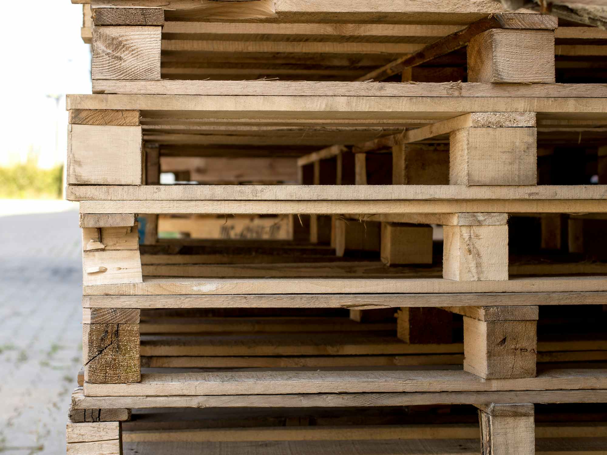 stack of wooden pallets stacked outside