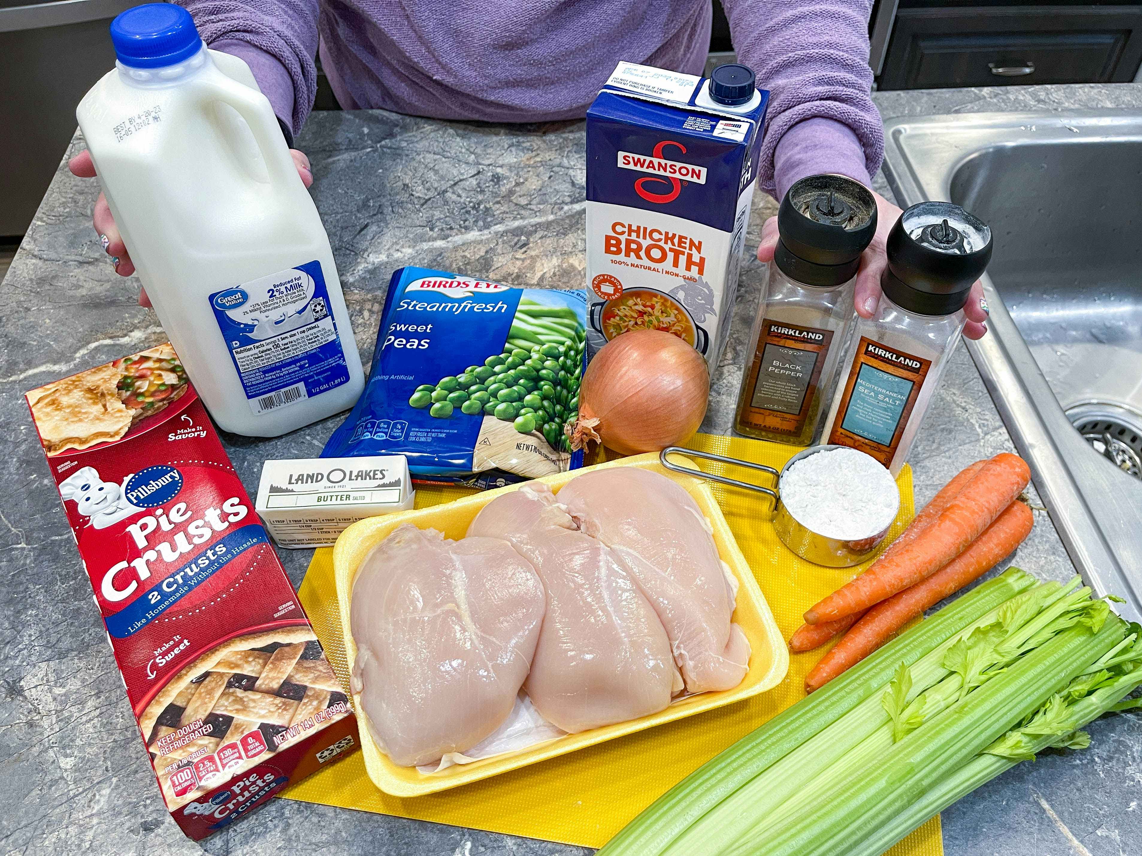 ingredients on a counter with a person ablout to make a freezer meals 