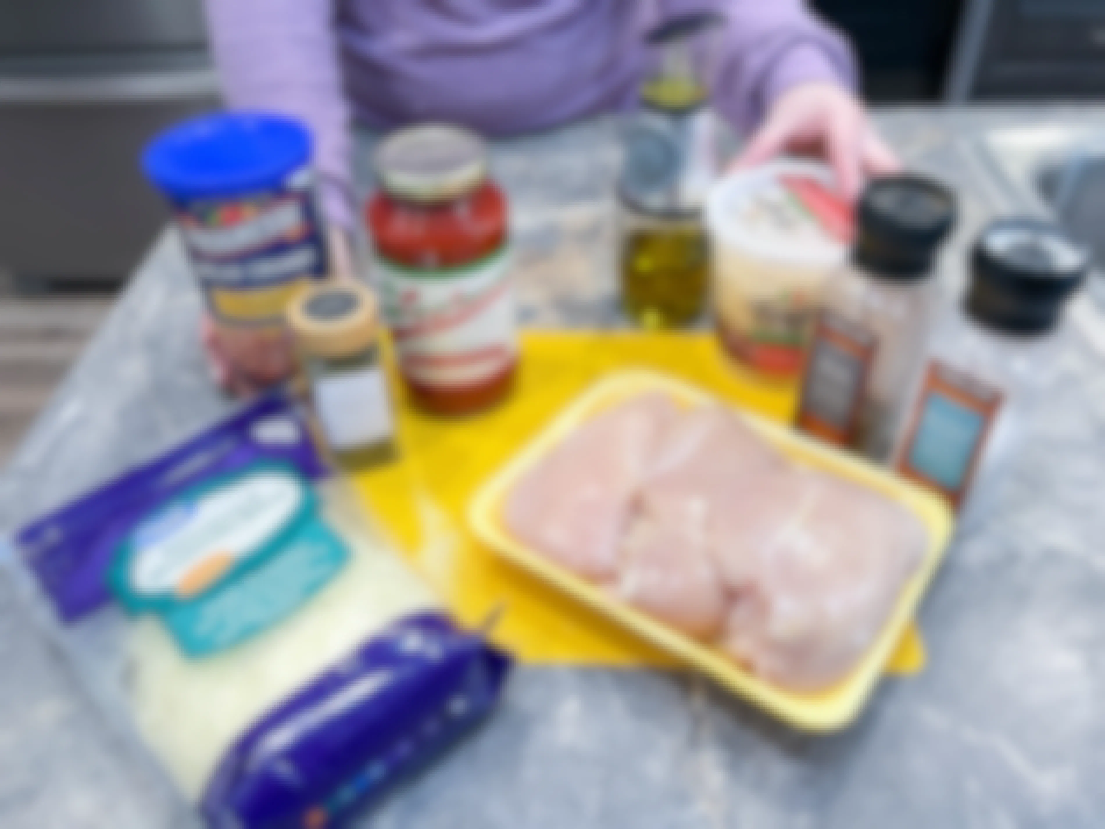 ingredients on a counter with a person about to make a freezer meals 