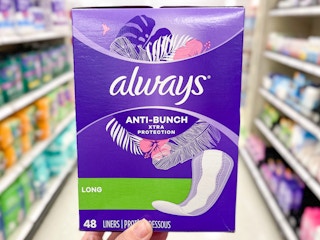 Someone holding Always panty liners in a store