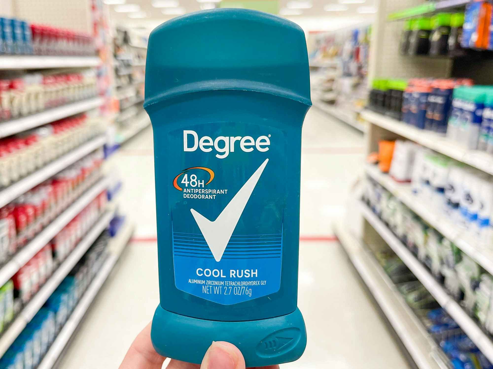 Someone holding Degree men's deodorant in a store