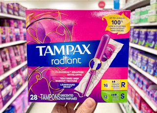 Someone holding Tampax Radiant tampons in a store