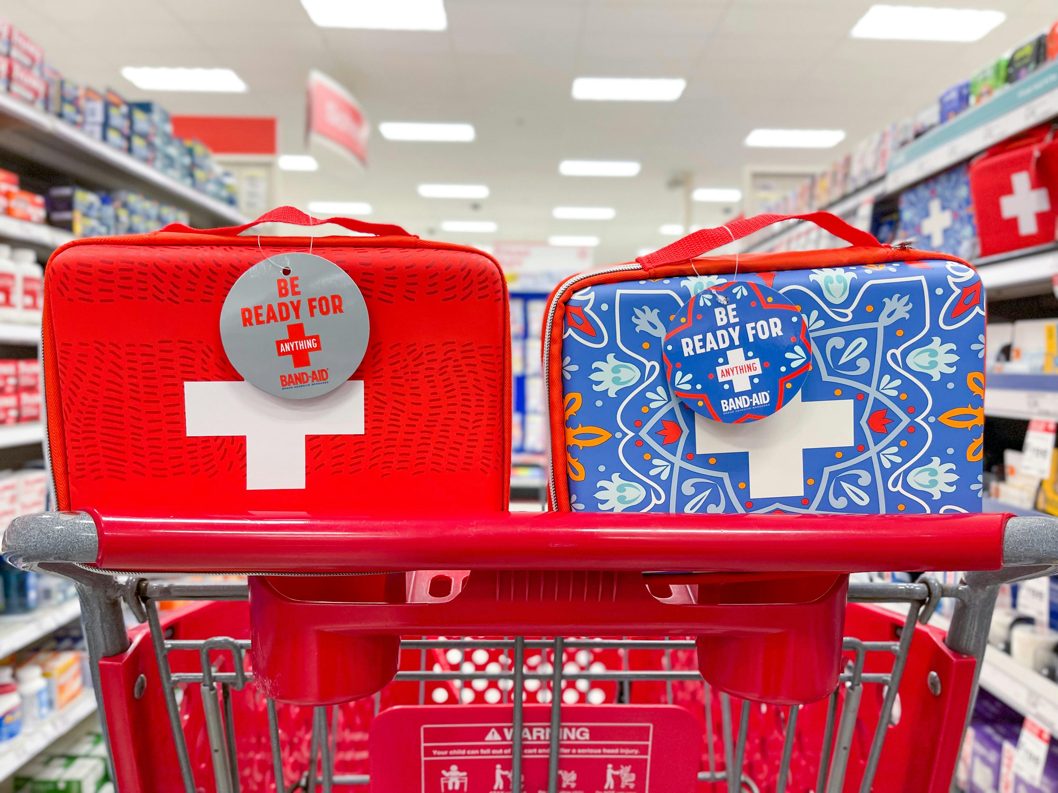 Red and blue first aid kits in a red target cart