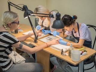 Beauty school students practicing nail services 
