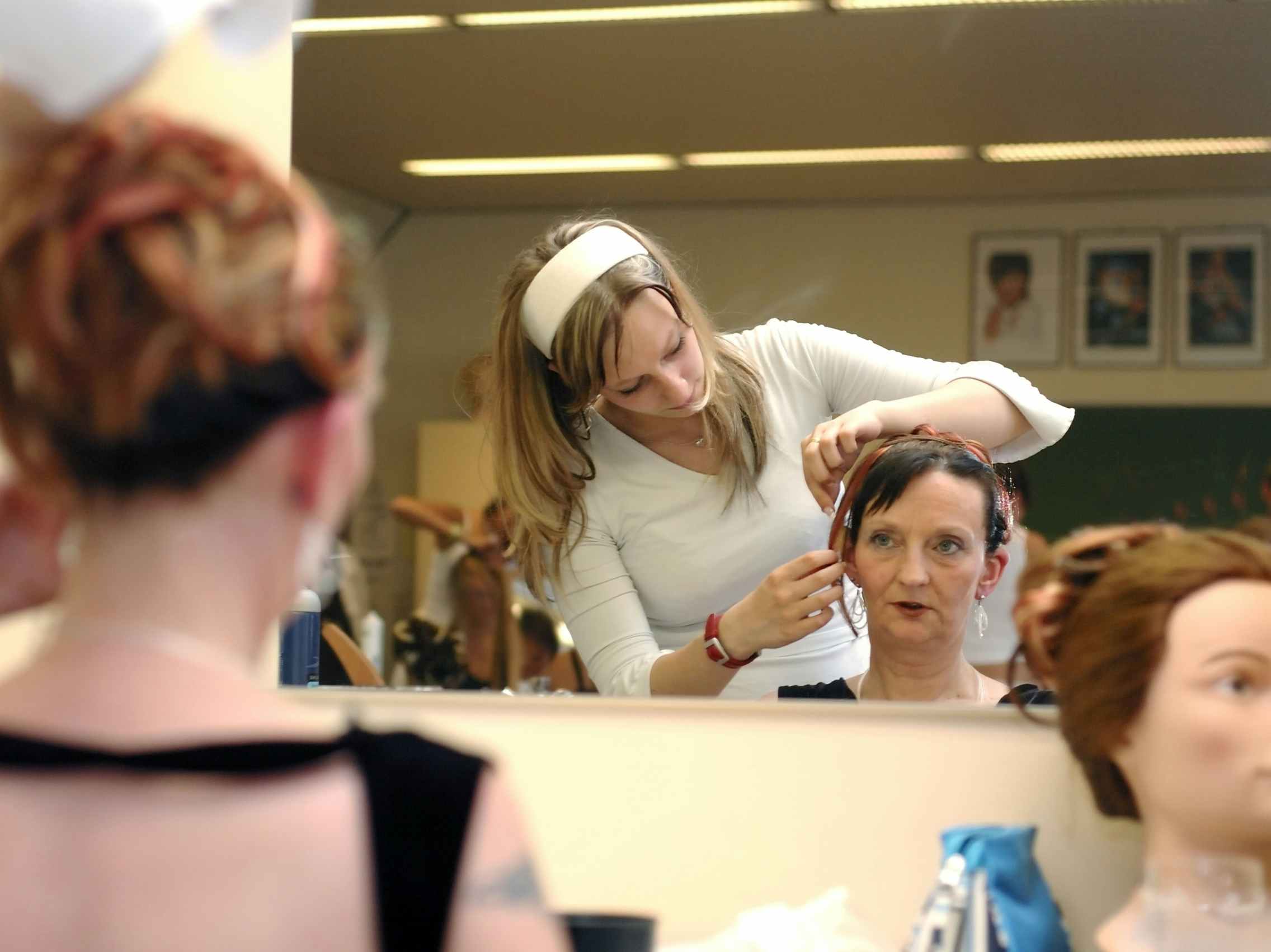 A hair dresser practicing on a person's hair