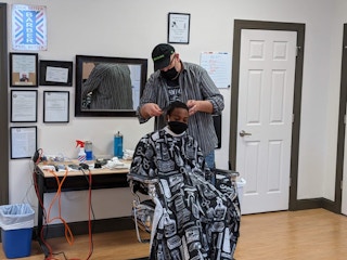 A person cutting someone's hair 