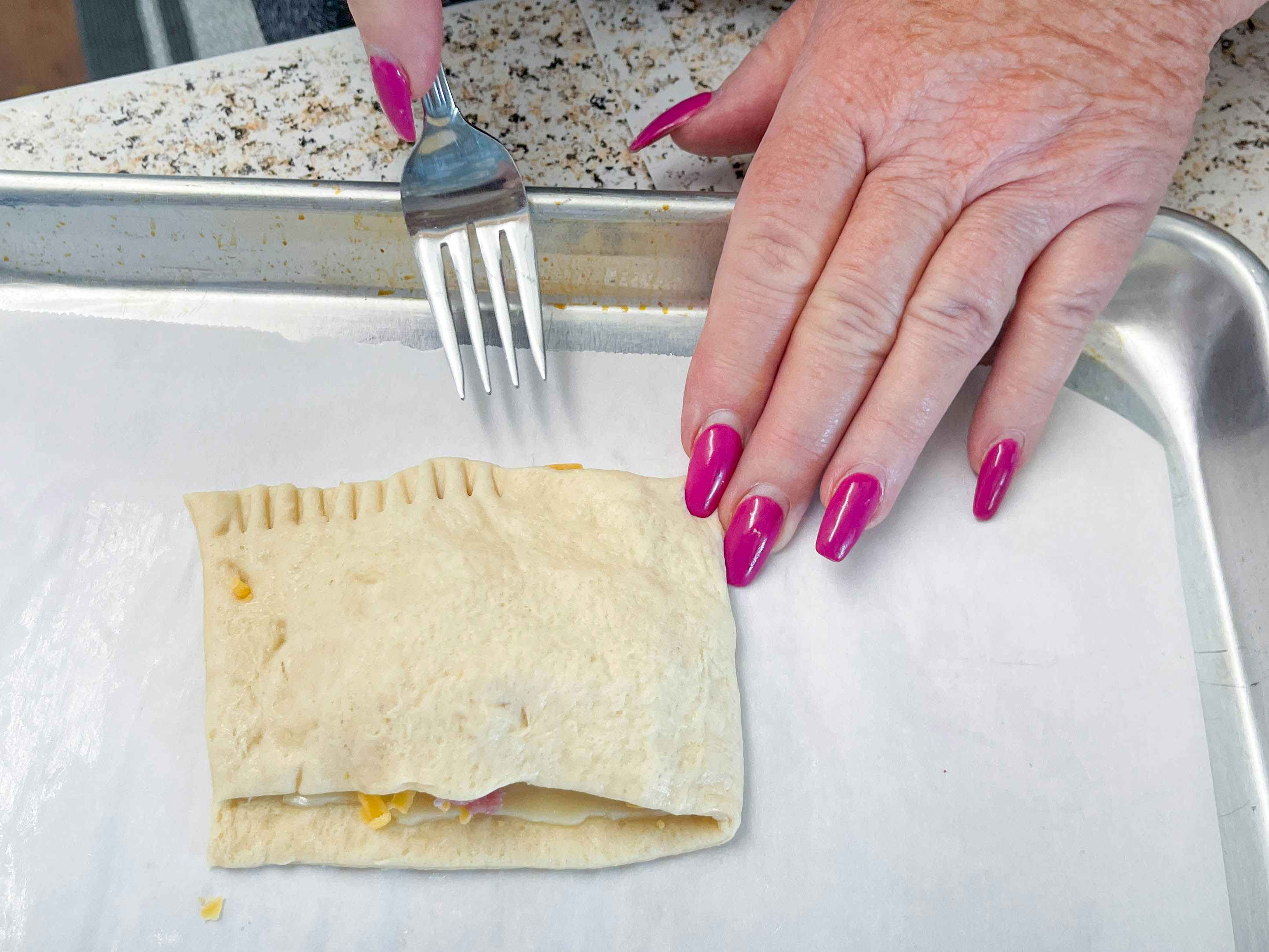a person using a fork to make a hot pocket 