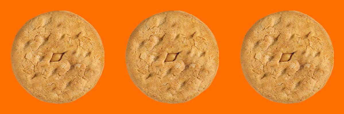 Three Girl Scout Do-Si-Dos cookies on an orange background