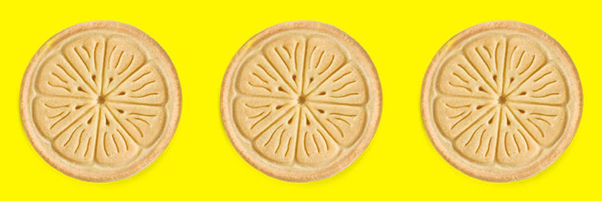 Three Girl Scout Lemonades cookies on a yellow background