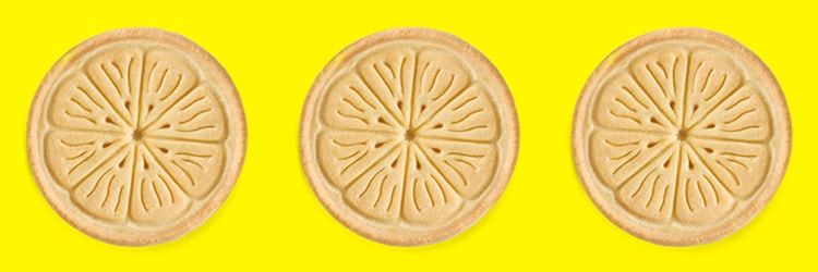 Three Girl Scout Lemonades cookies on a yellow background