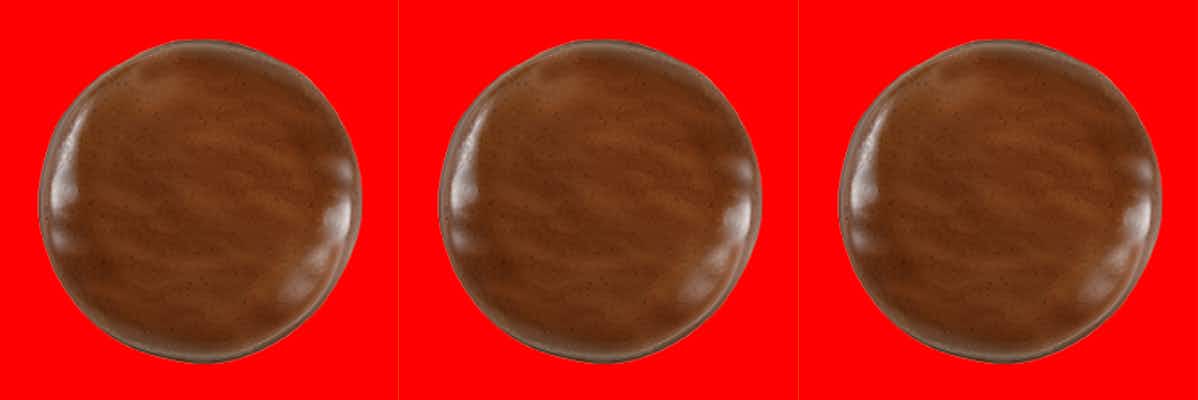 Three Girl Scout Tagalong cookies on a red background