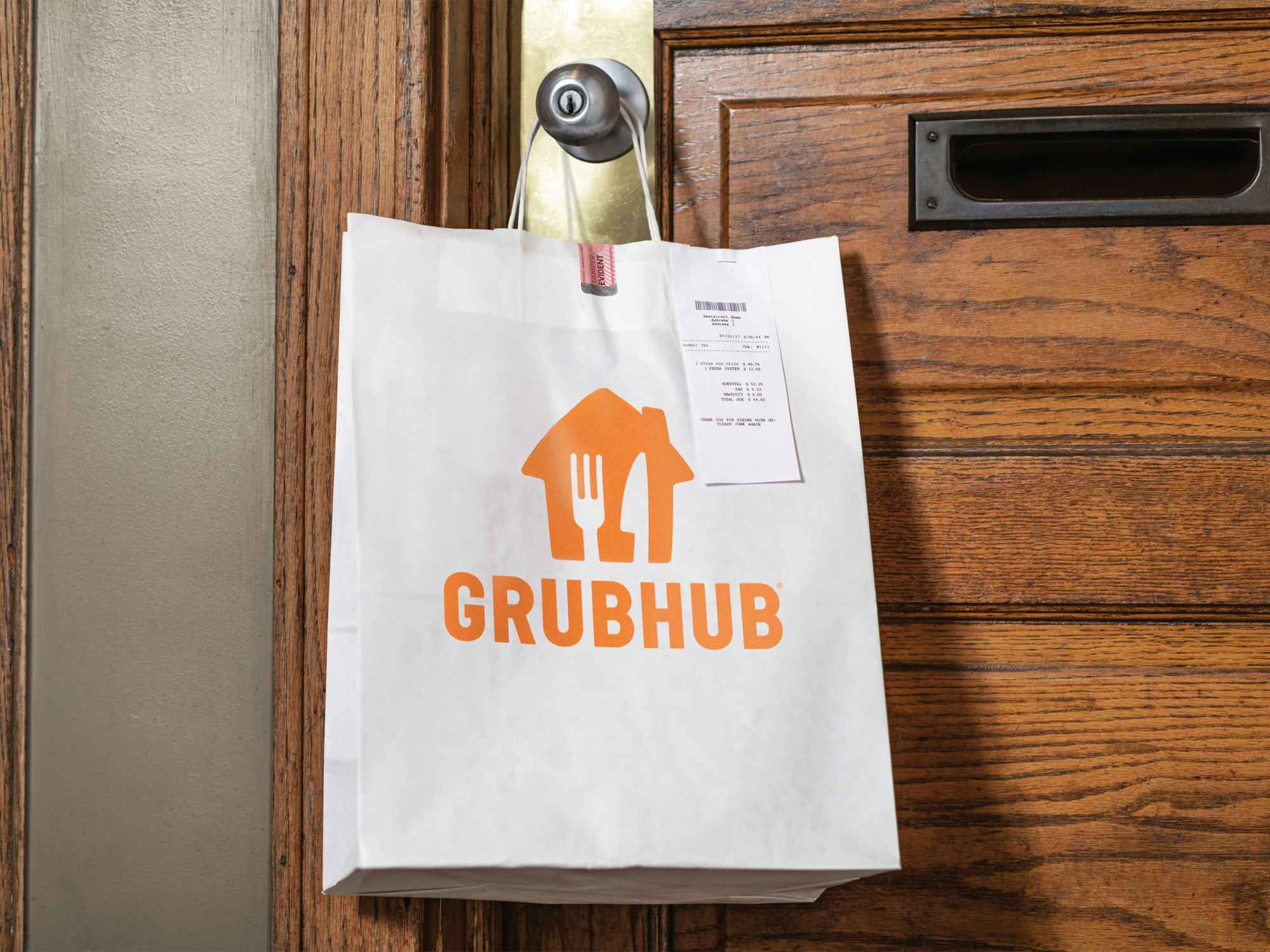 a grubhub delivery bag hanging on a doorknob