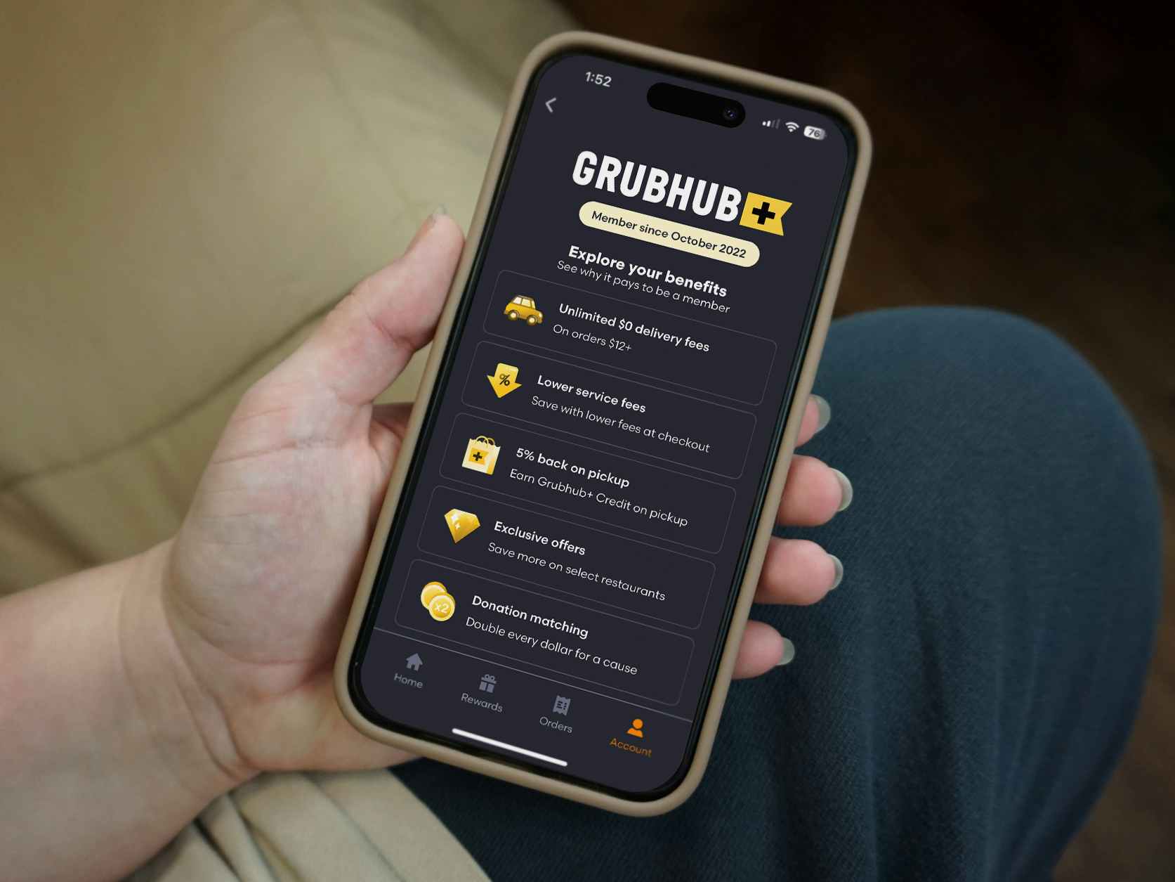someone holding a phone displaying the Grubhub plus membership page on the Grubhub app