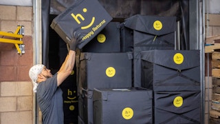 Happy Return truck being loaded with boxes by an Employee